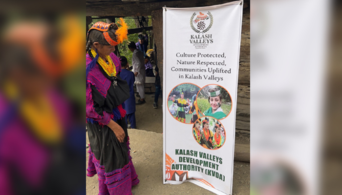 A girl looks at the Kailash Valleys banner at the Uchal festival released on August 23, 2024. — Facebook/@Kalash Valleys Development Authority