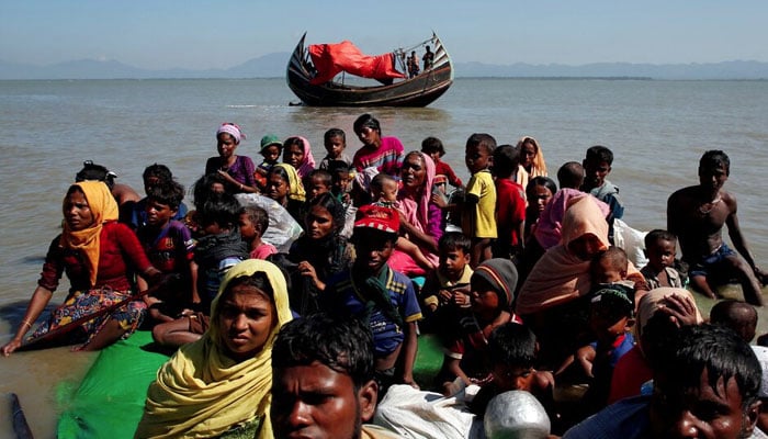 Rohingya refugees sit on a makeshift boat as they get interrogated by the Border Guard Bangladesh after crossing the Bangladesh-Myanmar border, at Shah Porir Dwip near Coxs Bazar, Bangladesh November 9, 2017. — Reuters