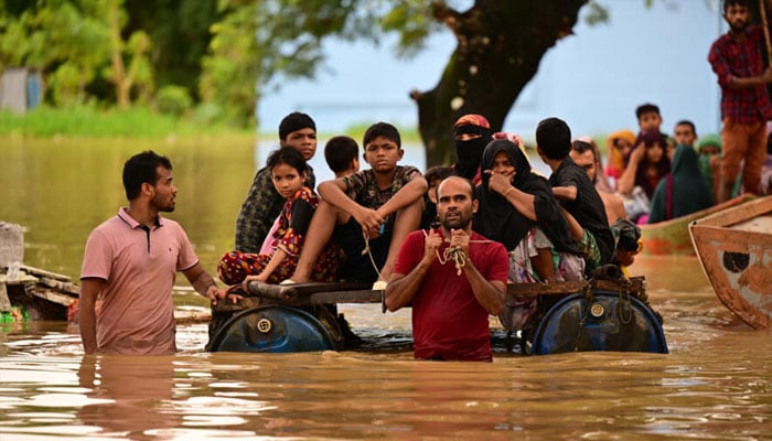 People seen amid flash floods in Bangladesh.— AFP/file