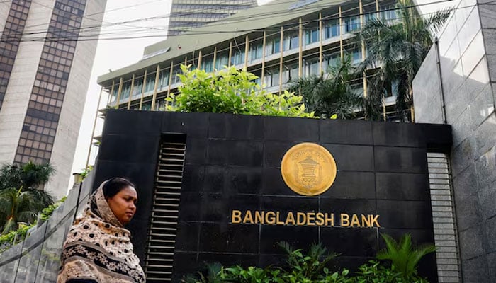 A woman passes by Bangladeshs central bank in Dhaka, Bangladesh on July 19, 2023. — Reuters