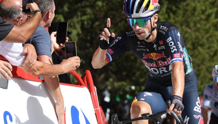 Primoz Roglic celebrates crossing the finish in first place, followed by Team Movistars Enric Mas. — AFP