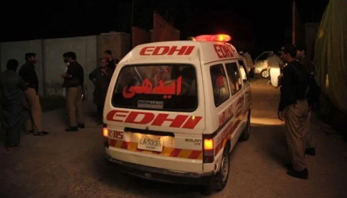 A representational image showing police personnel standing alongside an ambulance at an incident site. — AFP/File