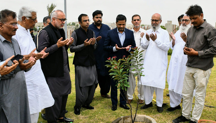 Commissioner Karachi Hasan Naqvi (2nd from centre), Senior Journalist Maqsood Yousufi (3rd from right), Additional Commissioner Ghulam Mehdi Shah, Deputy Commissioner East Shahzad Fazal Abbasi and others are praying after planting saplings on August 24, 2024. — Facebook/@Commissioner Karachi Office