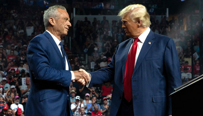 Former independent presidential candidate Robert F. Kennedy Jr (left) shakes hands with Republican presidential nominee and former US president Donald Trump during a campaign rally at Desert Diamond Arena on August 23, 2024 in Glendale, Arizona. — AFP