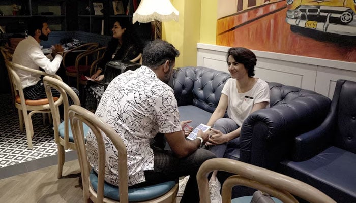 Uzma (R) chats with another attendee during a matchmaking event organised by the Muzz matrimony app at a cafe in Lahore, Pakistan on August 18, 2024. — Reuters