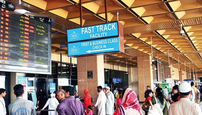 This image shows people standing at the Jinnah International Airport in Karachi to receive passengers. — AFP/File