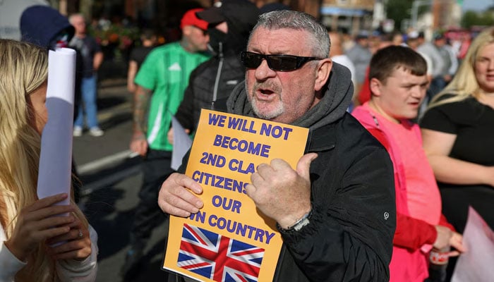 Protesters attend an anti-immigration protest in Belfast, Northern Ireland on August 9, 2024. — Reuters