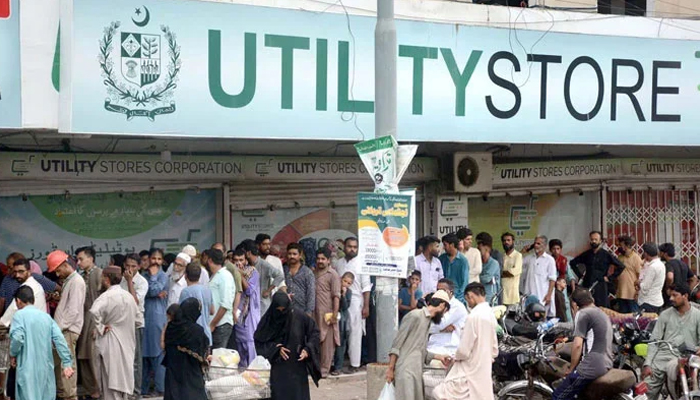 A long queue of people is seen outside a utility store in an undated picture. — APP/File