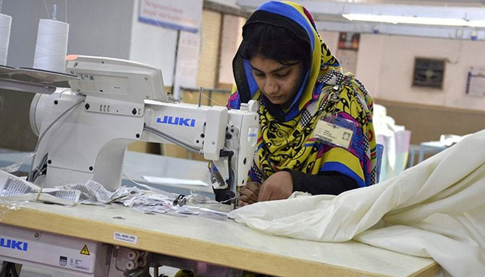 A female worker works at a textile factory in Faisalabad.— AFP/File