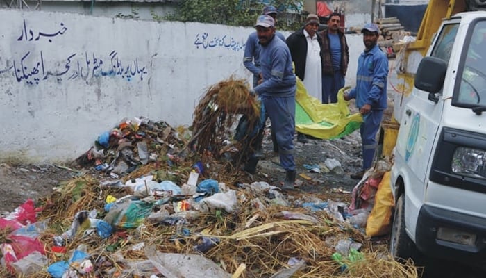 WASSCA workers clean a dumping site in this image on November 26, 2023. — Facebook/wsscabbottabadofficial