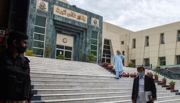 A lawyer walks past in front of the Peshawar High Court building seen in this image. — AFP/File