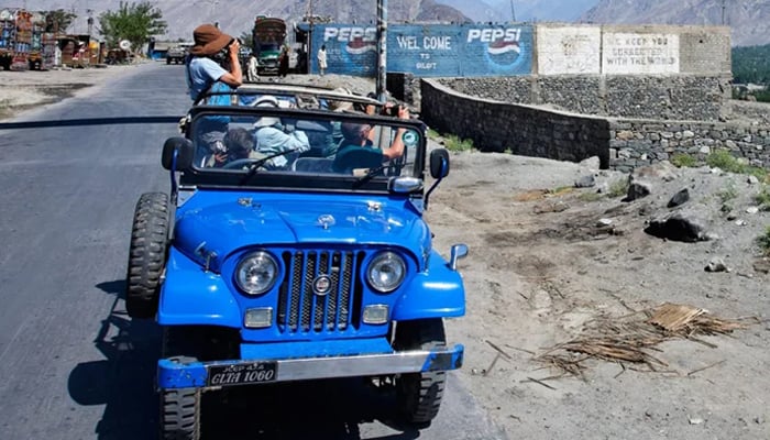 Tourists are in jeep and capturing photo by cell phone and camera at kaghan Valley seen in this image on July 30, 2024 — INP