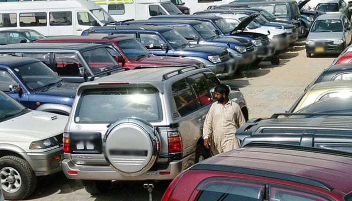 A person seen walking alongside parked cars. — AFP/File