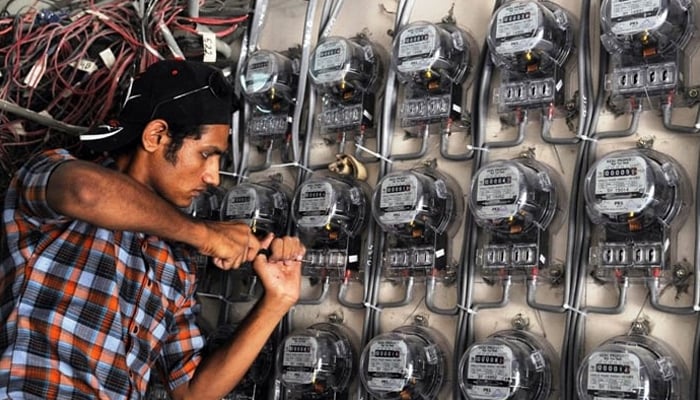 A power technician while fixing electric meters in KP — AFP/File