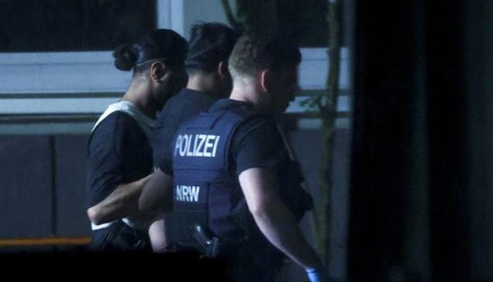 Police officers detain a person, following an incident in which several individuals were killed after a man randomly stabbed passers-by with a knife at a city festival, in Solingen, Germany, on Saturday. — Reuters