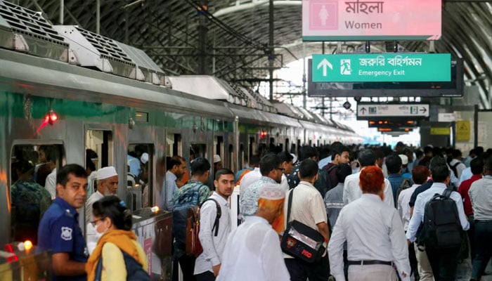 Passengers arrive at a metro train station in Dhaka on August 25, 2024. — AFP