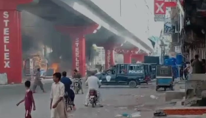 A still taken from a video shows a police van after armed clash between two groups in Golimar, Karachi on August 25, 2024. — Geo News website