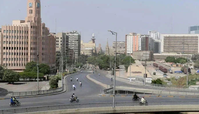 Commuters make their way through a partially deserted bridge in Karachi. — AFP/File