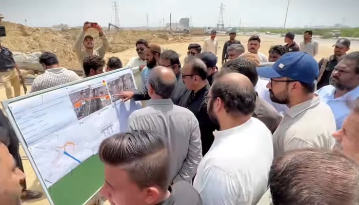 Sindh Local Government Minister Saeed Ghani is briefed by officials on under construction bridge on Korangi Causeway in Karachi on August 25, 2024. — Screengrab/Facebook/@SaeedGhaniPPP