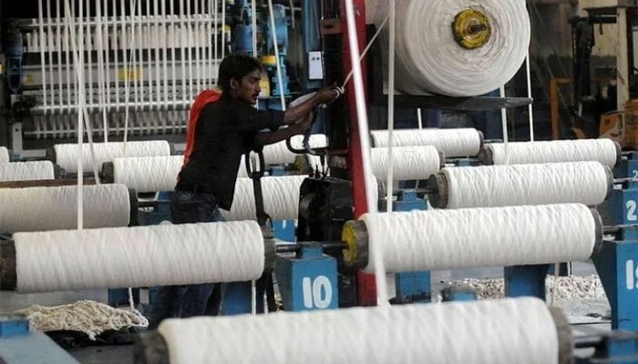 An employee working at a textile factory in Karachi on April 7, 2011. — AFP