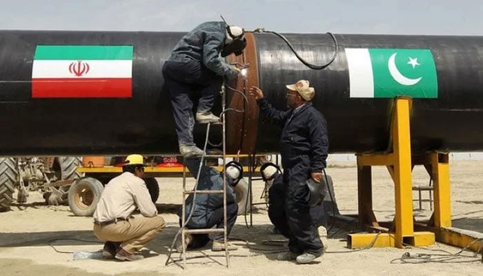 Workers can be seen busy working on a gas pipeline at Chabahar, Iran. — AFP/File