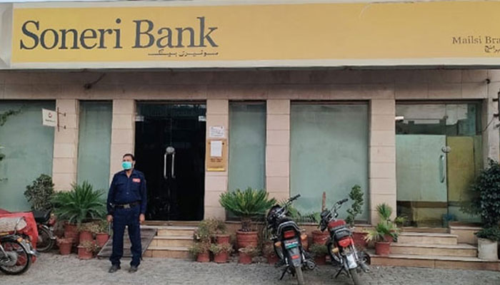 Security personnel stands outside the Soneri Bank Branch this image released on July 13, 2022. — Facebook/Soneri Bank Mailsi branch