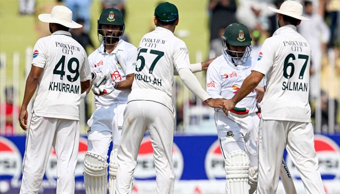 Bangladesh´s Shadman Islam (2L) and Zakir Hasan (2R) shake hands with Pakistan´s players after their team´s win at the end of the fifth and final day of the first Test cricket match between Pakistan and Bangladesh at the Rawalpindi Cricket Stadium in Rawalpindi on August 25, 2024.— AFP