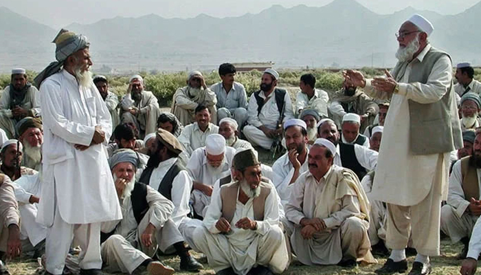 A representational image shows members of a Jirga sitting while an elder speaks. — AFP/File