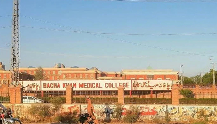 A man passes through outside the Bacha Khan Medical College on April 17, 2023. — Facebook/@bkmcyab