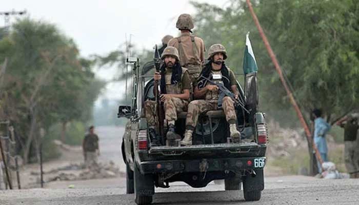 Armed security forces personnel ride on an army van. — AFP/File