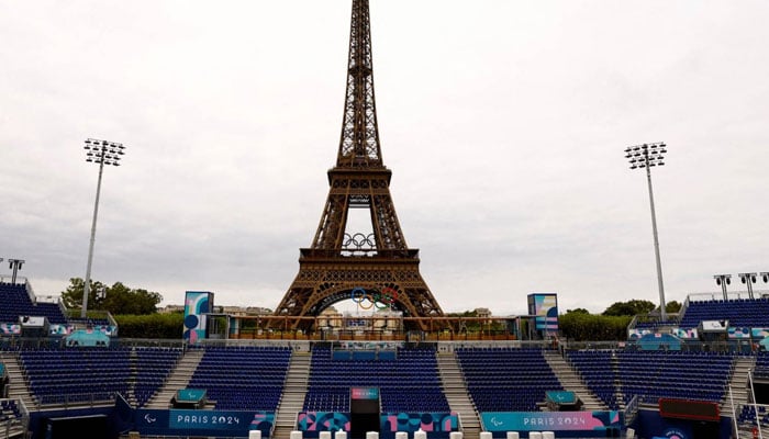 Workers work to convert the Eiffel Tower Stadium from the beach volleyball venue to the Paralympic blind football venue for the coming Paris 2024 Paralympic Games. — Reuters/file