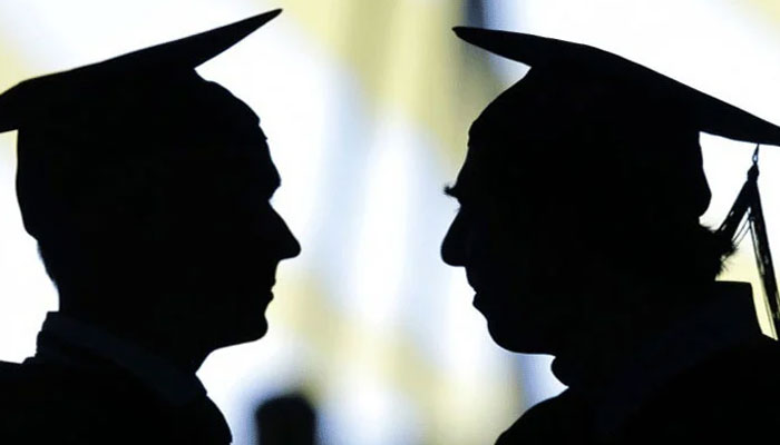 A representational image of the silhouette of two students wearing graduating caps. — AFP/File