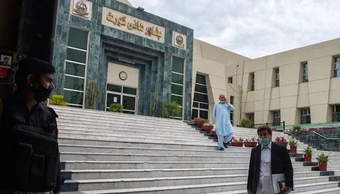 A lawyer walks past in front of the Peshawar High Court building seen in this image. — AFP/File