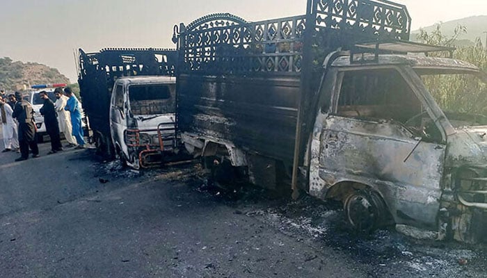 Burnt vehicles can be seen near the site of the incident where armed men offloaded and gunned down around two dozen people in Balochistans Musakhel on August 26, 2024. — State media