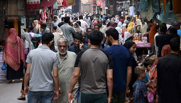 A representational image showing people in a market in Lahore. — AFP/File