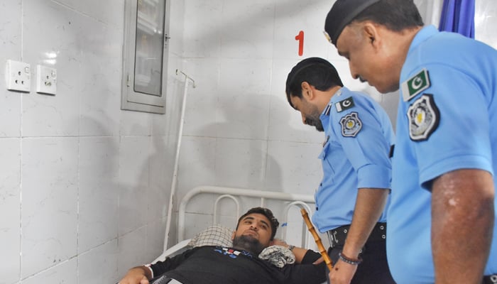 DIG Islamabad Dr. Syed Mustafa Tanveer along with the police official meeting the injured police constable Sami Ullah who is undergoing treatment at Pims Hospital image released on August 28, 2024. — Facebook/@islamabadpolice