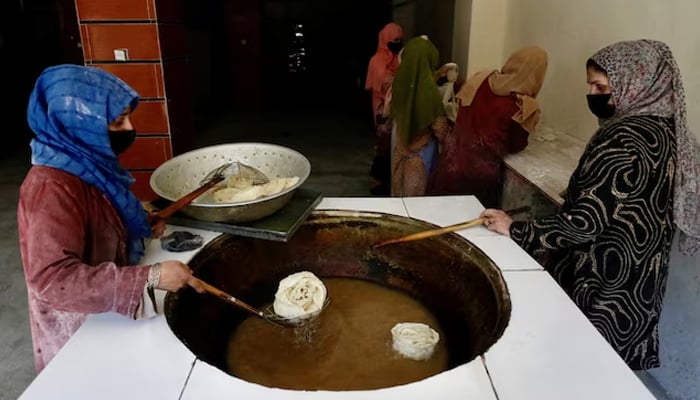 Afghan women fry traditional cookies inside a bakery in Kabul, Afghanistan, May 5, 2024. — Reuters