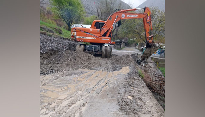 In this image district administrations machinery clearing roads blocked by the landslides and sludge left by the floods on April 14, 2024. — Facebook/@DCLowerChitral