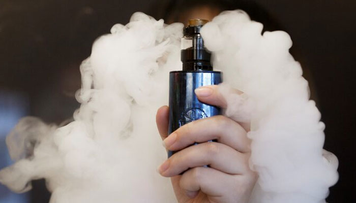 A saleswoman holds an e-cigarette as she demonstrates vaping at the Vape Shop that sells e-cigarette products on January 30, 2019. Reuters