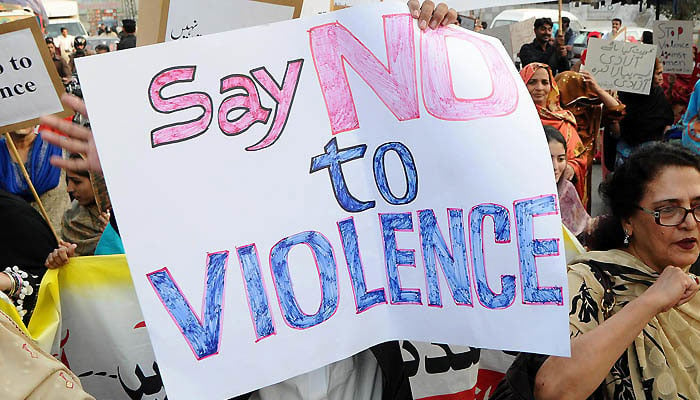 A representational image showing women carrying a placard against violence at a protest. — AFP/File