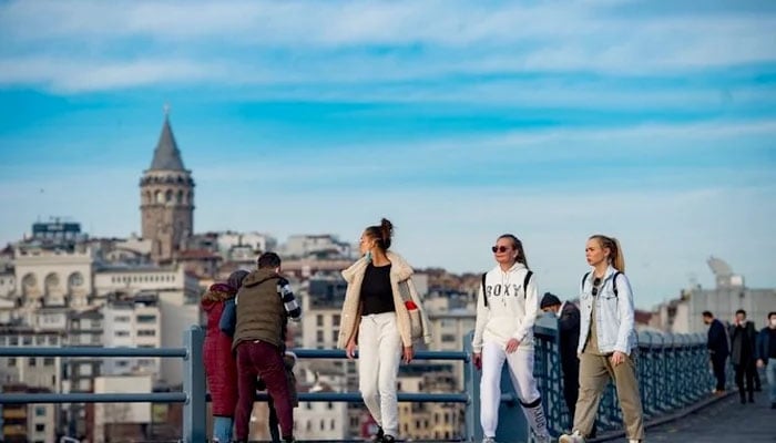 Tourists walk near Galata bridge in Istanbul, Turkey. — AFP/File