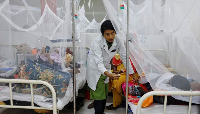 A nurse provides treatment to a dengue-infected patient at a hospital. — Reuters/File