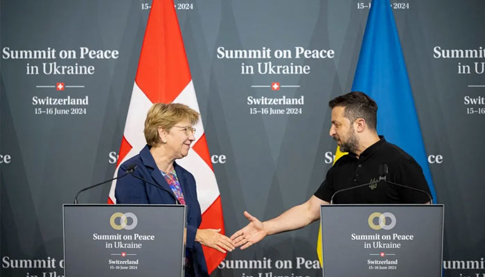 Swiss Federal President Viola Amherd (L) shakes hands with Ukraines President Volodymyr Zelensky during the closing press conference of the Summit on peace in Ukraine. — AFP