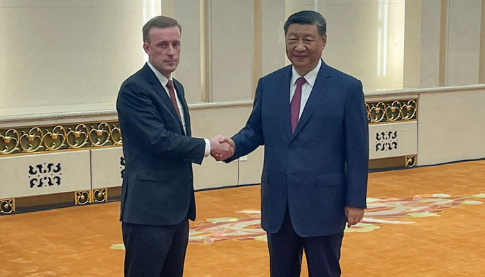 Sullivan (left) shakes hands with Xi during their meeting at the Great Hall of the People in Beijing today. — AFP/file