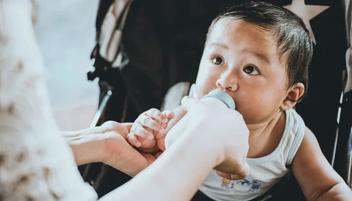 A representational image of an infant drinking baby formula milk. — Unsplash/File