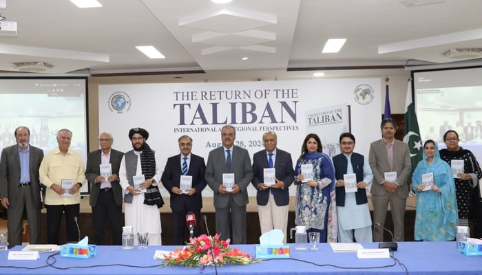 Pakistan’s Special Representative on Afghanistan Asif Durrani (centre) and others pose for a group photo at the book launch of ISS Director Amina Khans The Return of the Taliban  on August 28, 2024. — Facebook/@Institute.of.Strategic.Studies.Islamabad