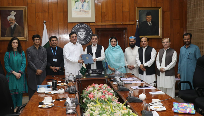 University of Peshawar Vice Chancellor Prof Dr Muhammad Naeem Qazi (centre) and Chief CPWC Ijaz Khan (4th from left) showing the signed MoU documents to build synergy for the nascent regional child protection centre on August 30, 2024. — Facebook/@shakeel.ahmed.33483