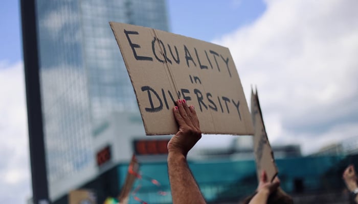 This representational image shows a person with disabilities holding a placard. — Unsplash/File