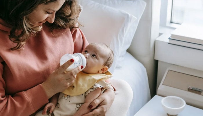 A representational image showing a woman feeding formula milk to an infant. — Pexels/File