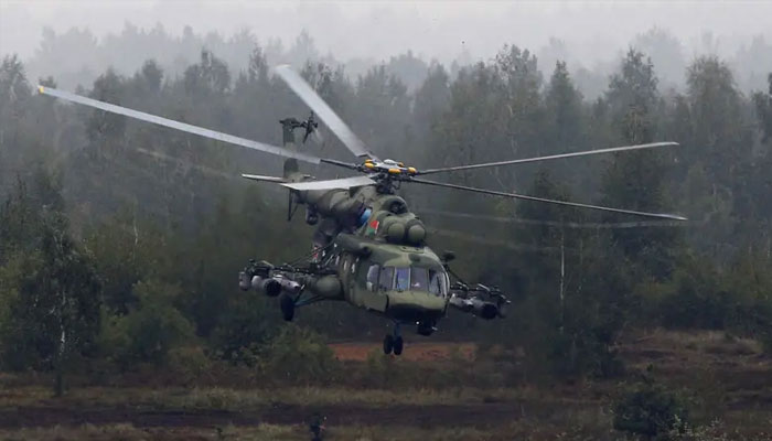 A Mi-8 helicopter flies above servicemen during the Zapad 2017 war games at a range near the town of Borisov, Belarus September 20, 2017. — Reuters